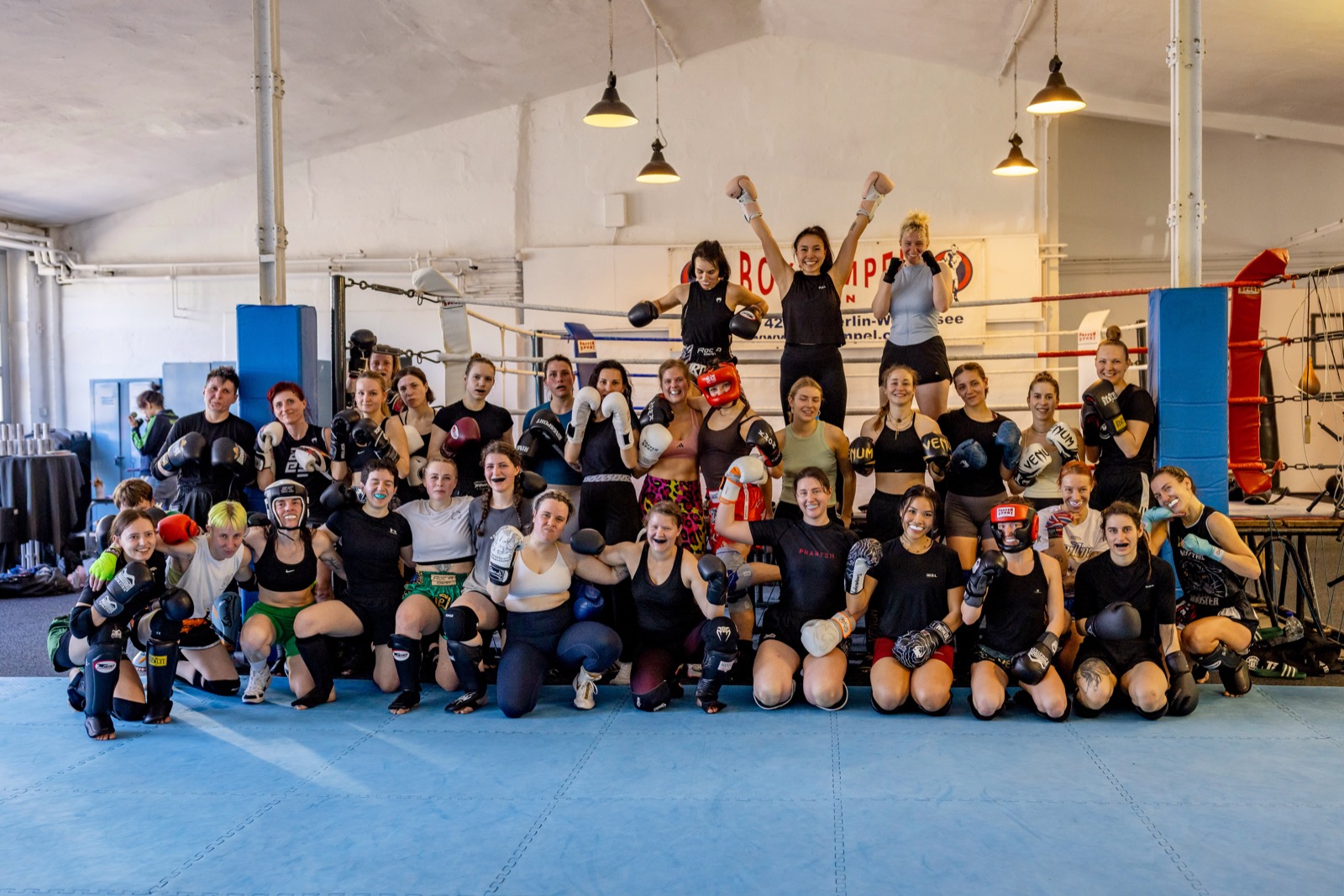Women practicing grappling drill at HERA open mat event